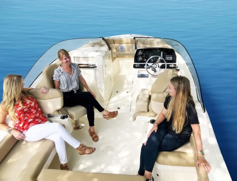 Slide: The Image of Three people relaxing on a 2025 Scout 215 Dorado boat, enjoying a sunny day. - 46