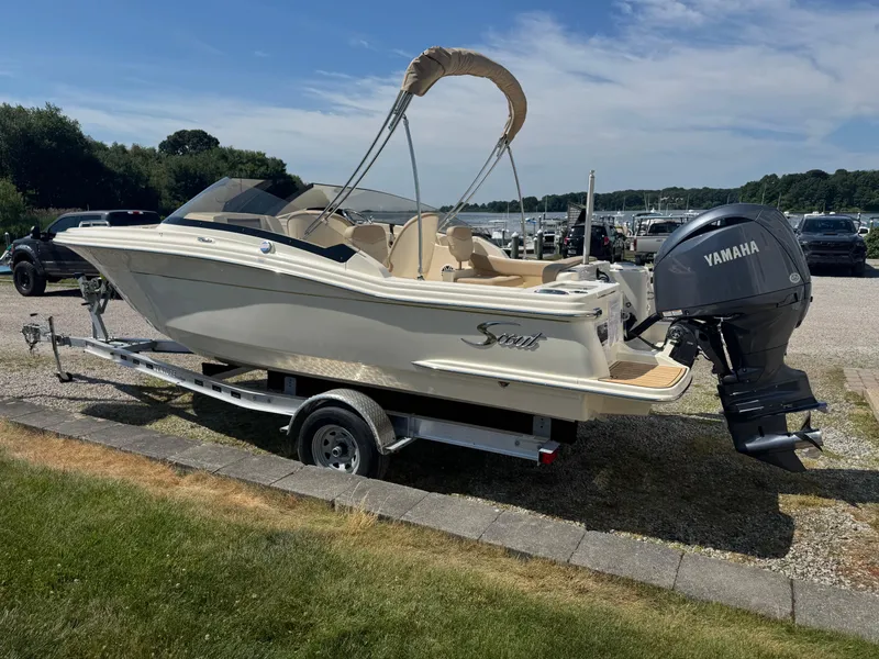 Slide: The Image of 2025 Scout 215 Dorado boat on trailer with Yamaha outboard motor, parked outdoors. - 5