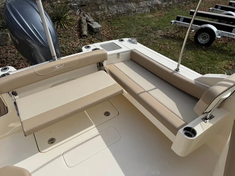 Slide: The Image of 2025 Scout 215 Dorado boat interior with beige seating and cup holders. - 51