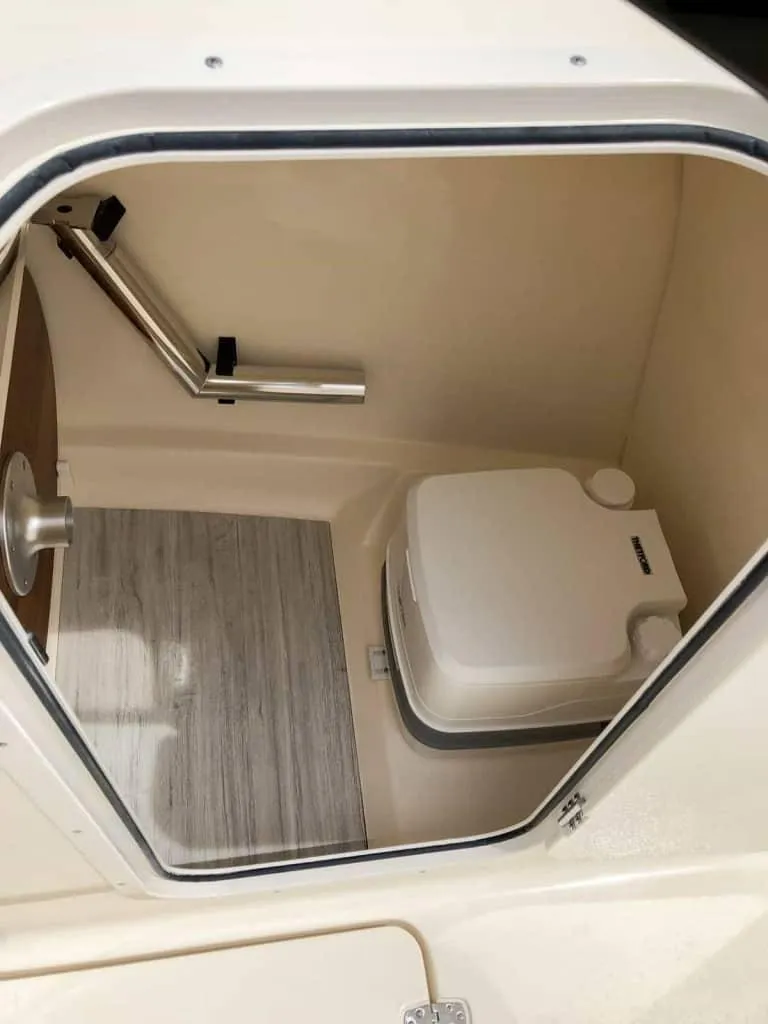 Slide: The Image of 2025 Scout 215 Dorado boat interior with compact marine toilet. - 54