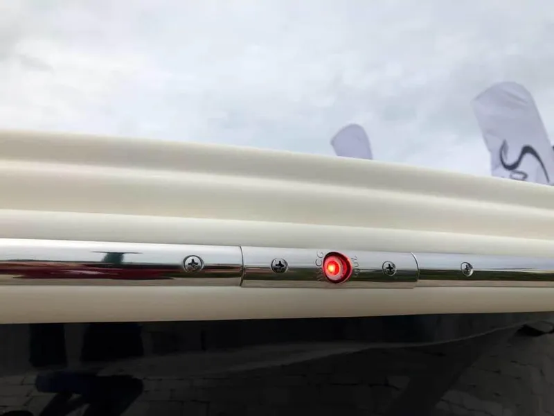 Slide: The Image of 2025 Scout 215 Dorado boat with red LED light on chrome rail. - 57