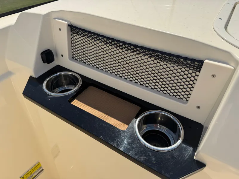 Slide: The Image of 2025 Scout 215 Dorado boat console with cup holders and storage net. - 8