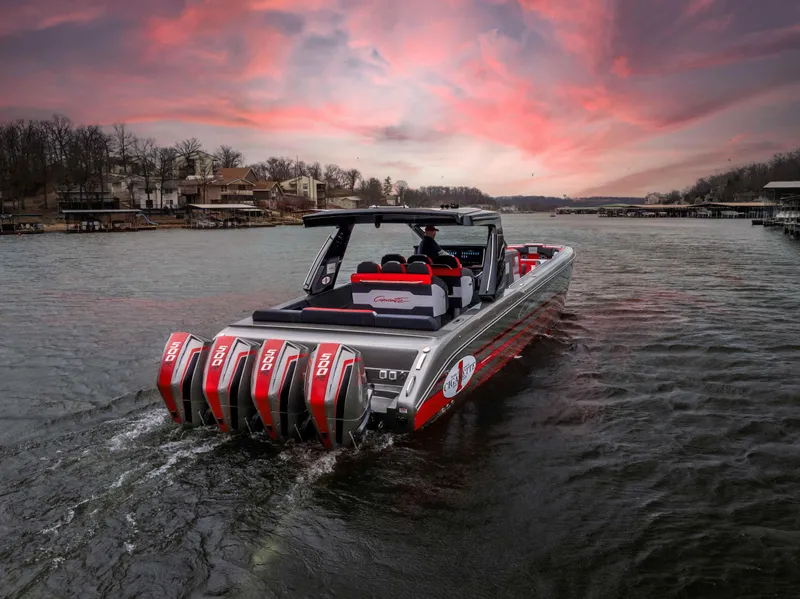 Slide: The Image of 2025 Cigarette 41 Nighthawk boat on water at sunset, featuring multiple engines. - 0