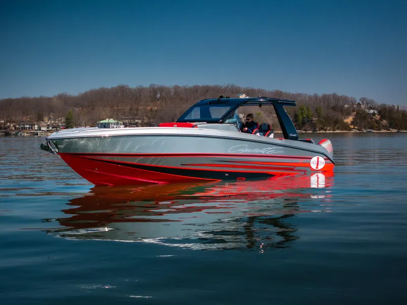 Slide: The Image of 2025 Cigarette 41 Nighthawk boat on calm water, featuring sleek red and gray design. - 1