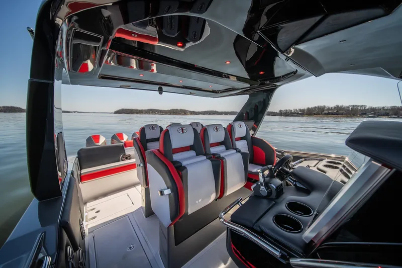 Slide: The Image of 2025 Cigarette 41 Nighthawk boat interior with sleek seating and modern design on a calm lake. - 11