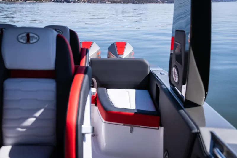 Slide: The Image of 2025 Cigarette 41 Nighthawk boat interior with red and white seating on calm water. - 14