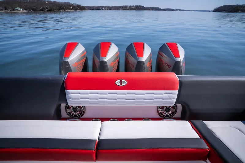 Slide: The Image of 2025 Cigarette 41 Nighthawk boat with red and white seating, five powerful engines on a calm lake. - 17