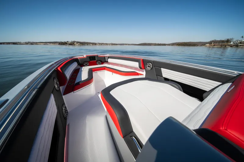Slide: The Image of 2025 Cigarette 41 Nighthawk boat interior with red and white seating on calm water. - 22
