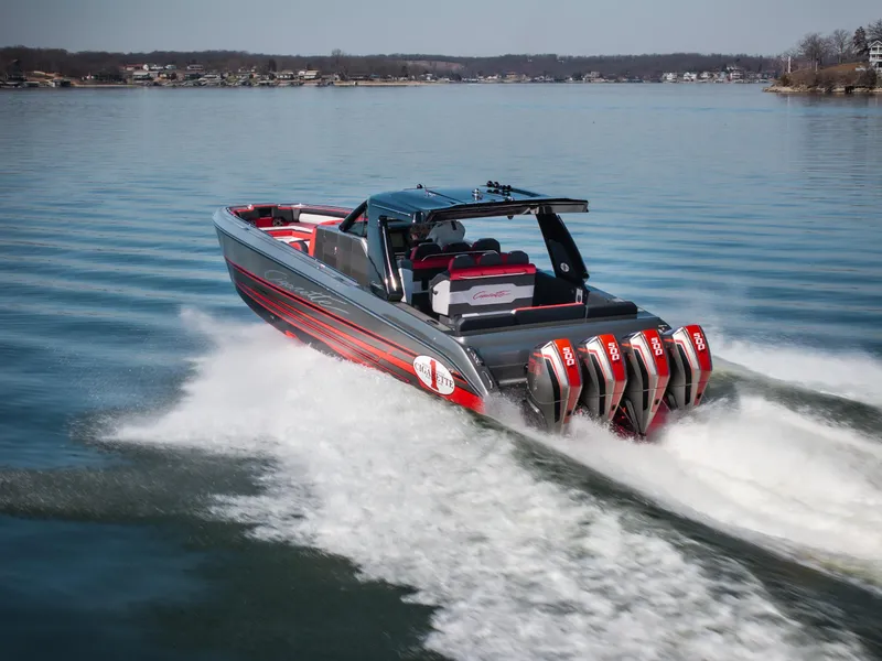 Slide: The Image of 2025 Cigarette 41 Nighthawk speedboat with four engines cruising on a calm lake. - 7