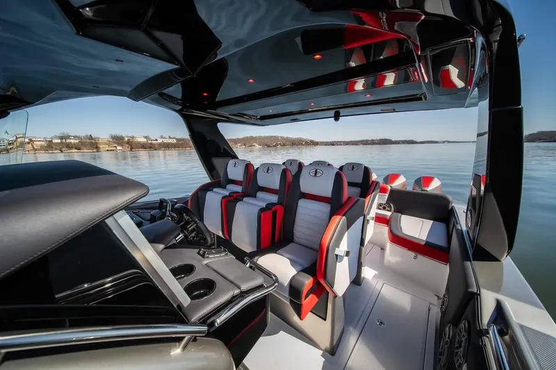 Slide: The Image of 2025 Cigarette 41 Nighthawk boat interior with modern seating and sleek design on calm water. - 8