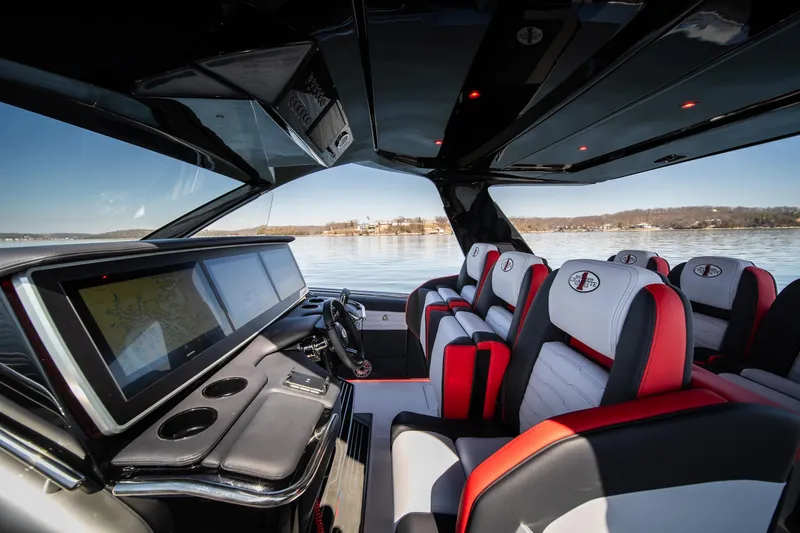 Slide: The Image of 2025 Cigarette 41 Nighthawk interior with modern dashboard and luxurious seating on a lake. - 9