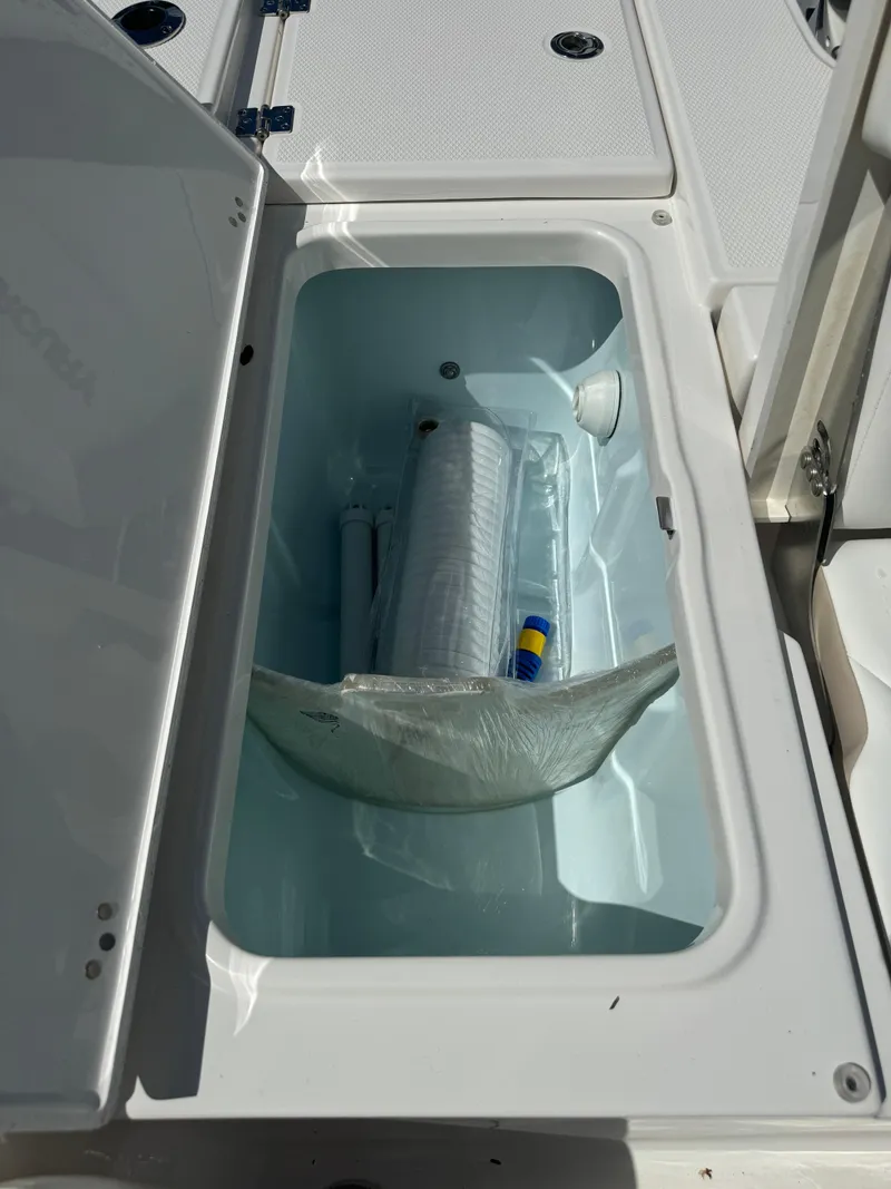 Slide: The Image of Open storage compartment on 2025 Robalo 266 Cayman SD boat. - 16