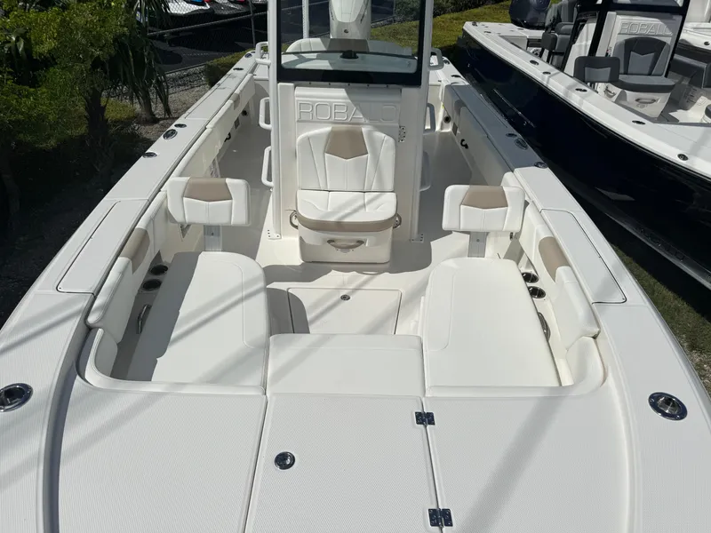 Slide: The Image of 2025 Robalo 266 Cayman SD boat interior with white seating and console. - 21