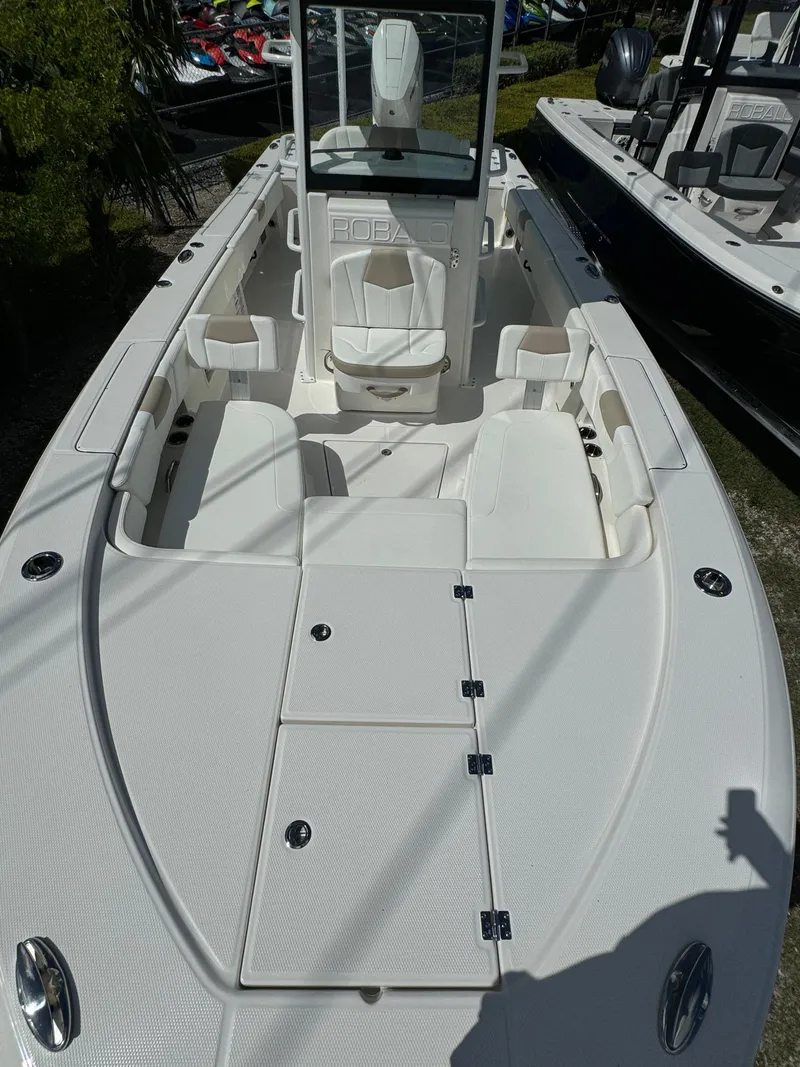 Slide: The Image of 2025 Robalo 266 Cayman SD boat, spacious deck, sleek design, white interior. - 22