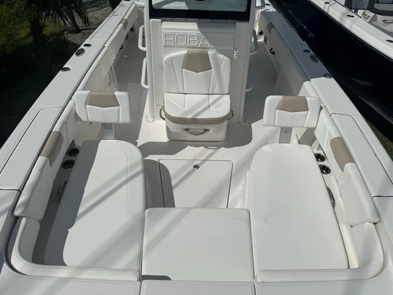 Slide: The Image of 2025 Robalo 266 Cayman SD boat interior with white seating and console. - 24