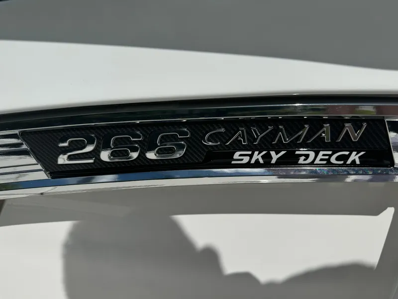 Slide: The Image of Robalo 266 Cayman SD 2025 boat emblem with "Sky Deck" text. - 27