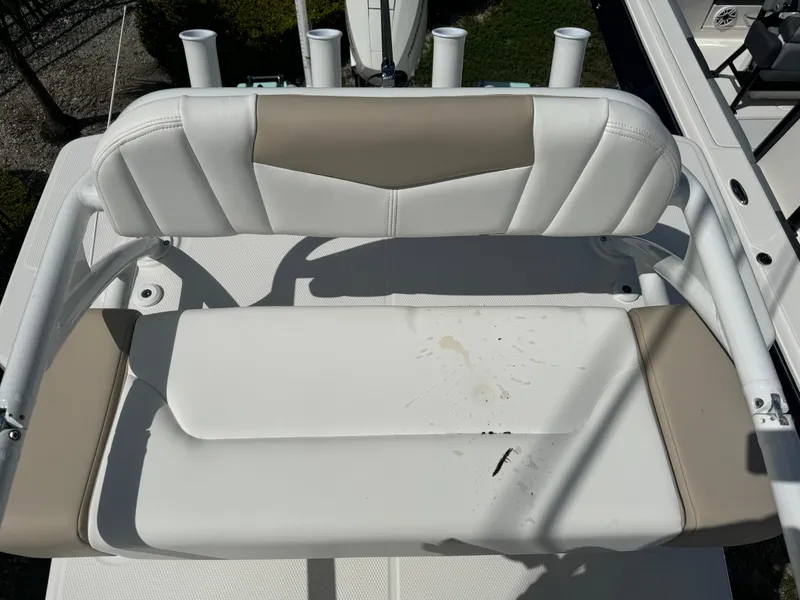 Slide: The Image of 2025 Robalo 266 Cayman SD boat seat with white and beige upholstery. - 31