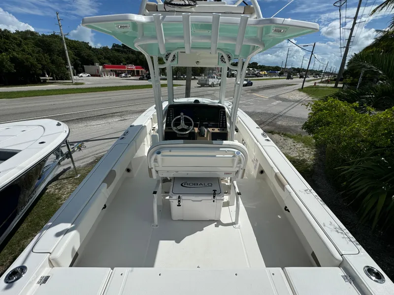 Slide: The Image of 2025 Robalo 266 Cayman SD boat, center console, white interior, parked near road. - 6