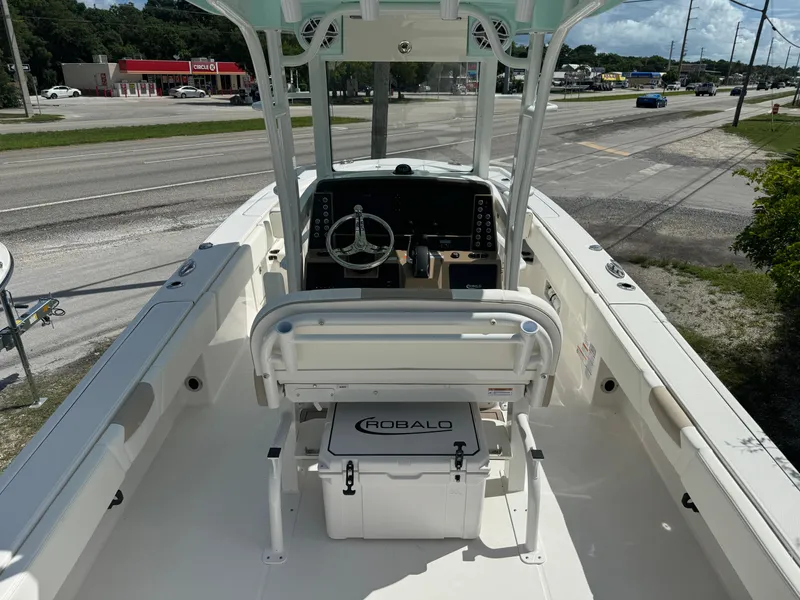 Slide: The Image of 2025 Robalo 266 Cayman SD boat interior with steering console and seating. - 7