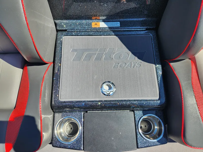 Slide: The Image of 2024 Triton 18 TrX boat interior with storage compartment and cup holders. - 14