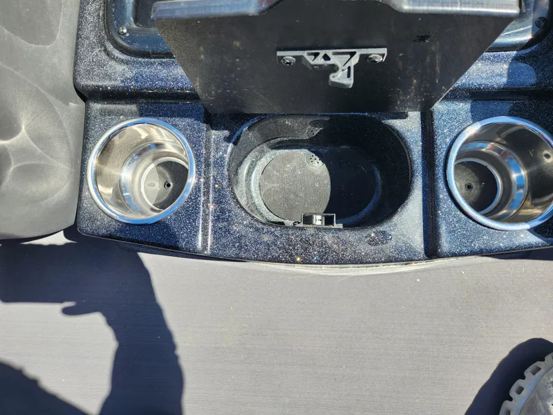 Slide: The Image of 2024 Triton 18 TrX boat console with cup holders and storage compartment. - 16