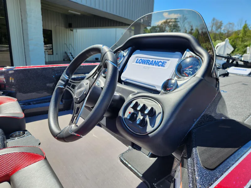 Slide: The Image of 2024 Triton 18 TrX boat dashboard with Lowrance display and steering wheel. - 17