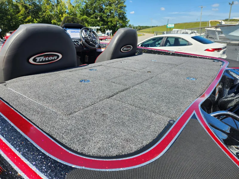 Slide: The Image of 2024 Triton 18 TrX boat interior with gray carpet and dual seats. - 19