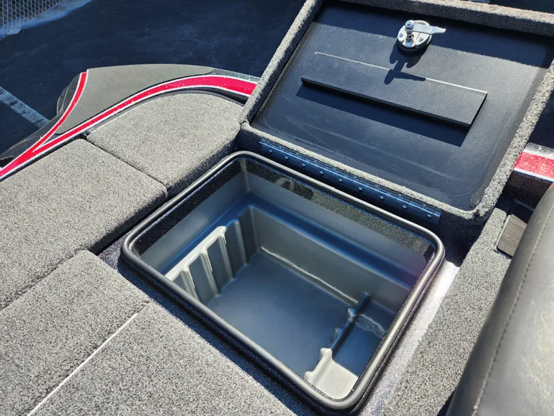 Slide: The Image of 2024 Triton 18 TrX boat storage compartment, open lid, gray interior, red accents. - 21