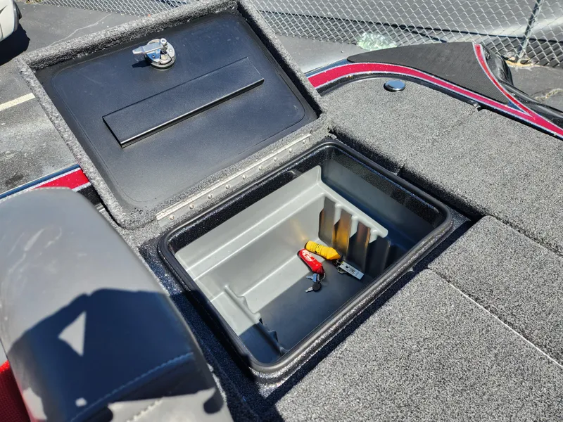 Slide: The Image of 2024 Triton 18 TrX boat storage compartment with open lid and organized interior. - 22