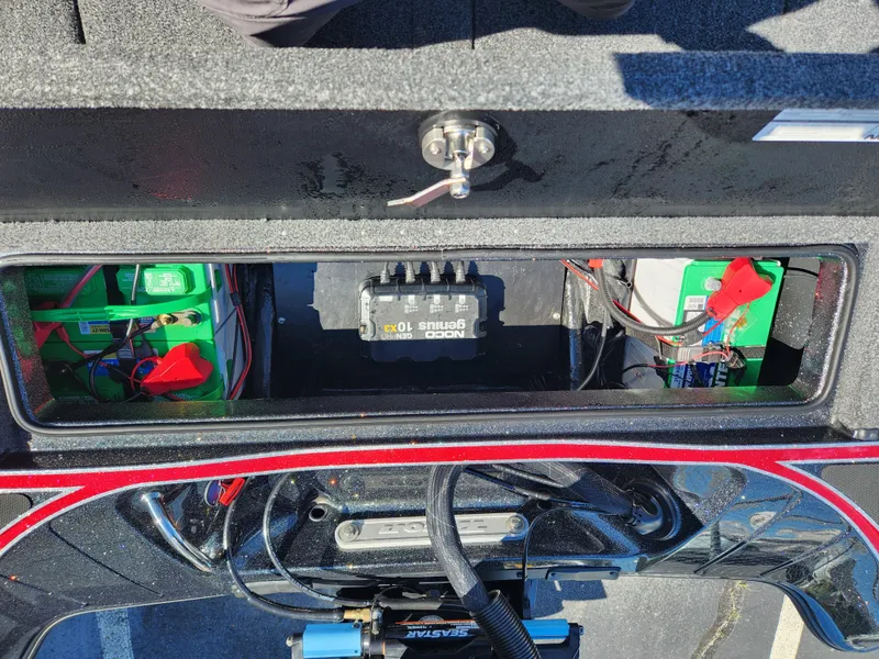 Slide: The Image of 2024 Triton 18 TrX boat battery compartment with wiring and components. - 24