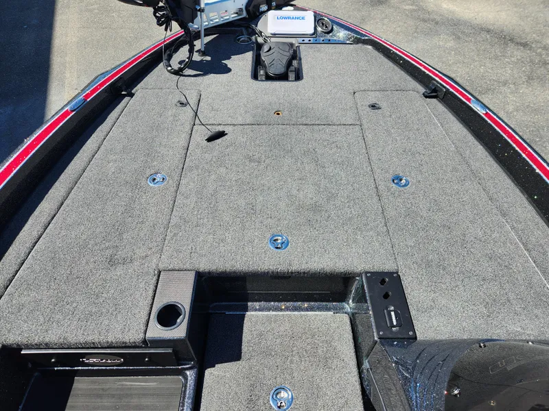 Slide: The Image of 2024 Triton 18 TrX boat deck with fishing equipment and storage compartments. - 7