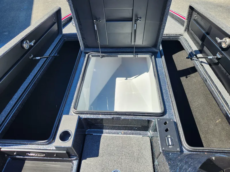 Slide: The Image of 2024 Triton 18 TrX boat storage compartments open, showcasing spacious interior design. - 8
