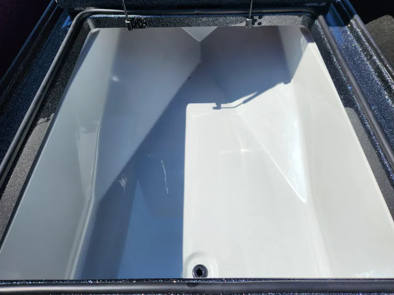 Slide: The Image of 2024 Triton 18 TrX boat storage compartment, open and empty. - 9