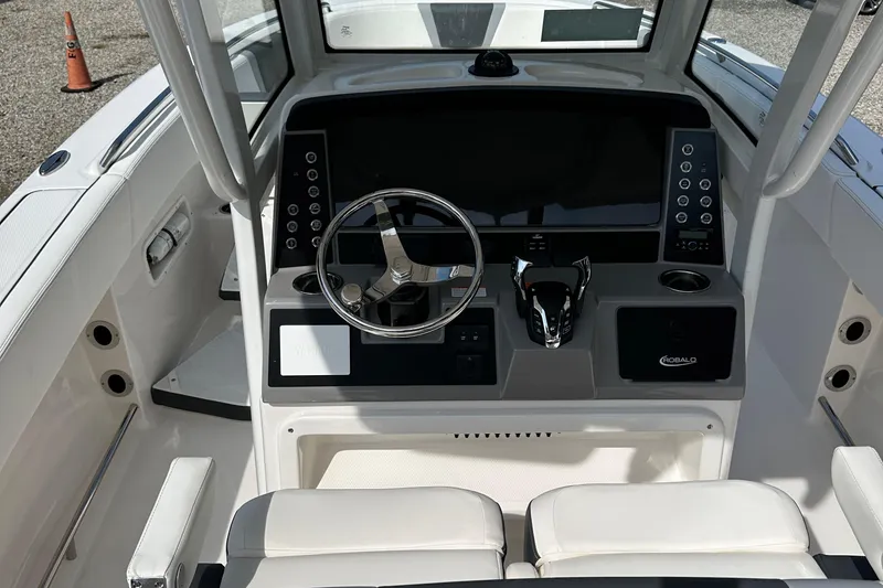 Slide: The Image of 2025 Robalo R250 Center Console boat dashboard with steering wheel and controls. - 7