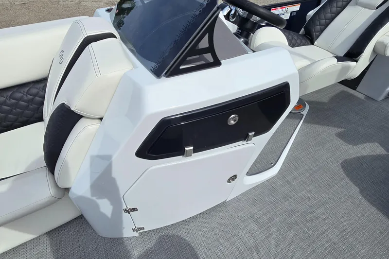 Slide: The Image of 2025 Manitou 27 boat interior with modern seating and sleek console design. - 3
