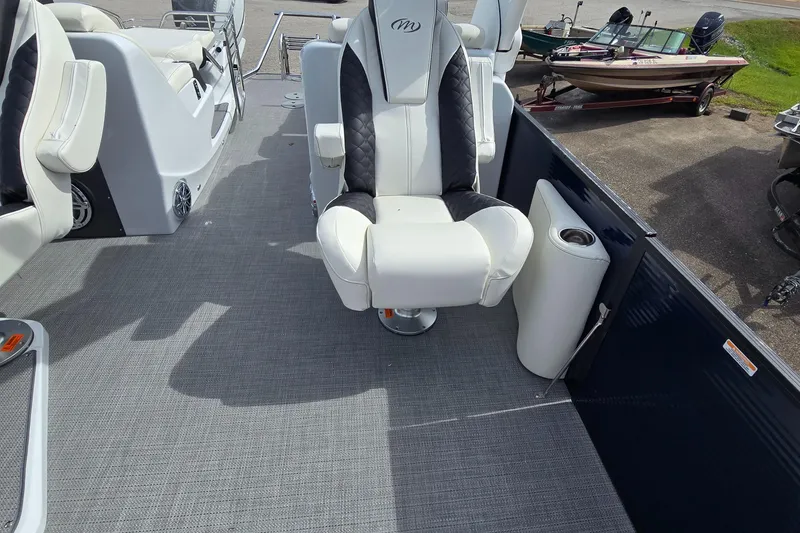 Slide: The Image of 2025 Manitou 27 boat interior with luxurious seating and modern design. - 5