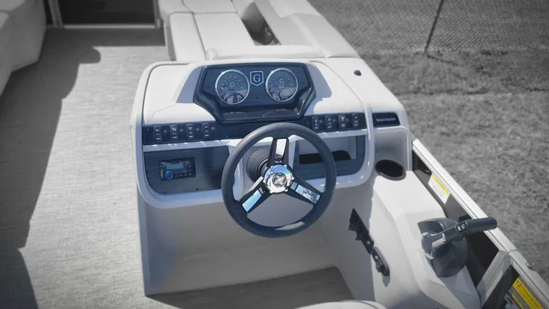 Slide: The Image of 2025 Godfrey SWEETWATER 2286 SB boat dashboard with steering wheel and controls. - 7