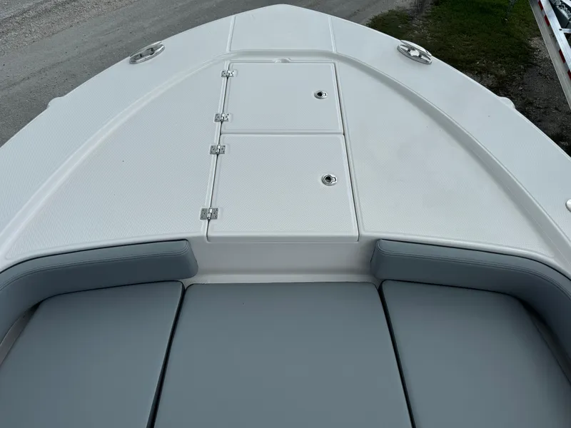 Slide: The Image of 2025 Robalo 246 Cayman boat deck with cushioned seating and storage compartments. - 10