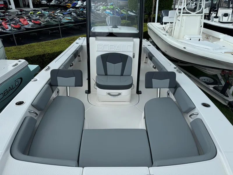 Slide: The Image of 2025 Robalo 246 Cayman boat interior with gray seating and console. - 11