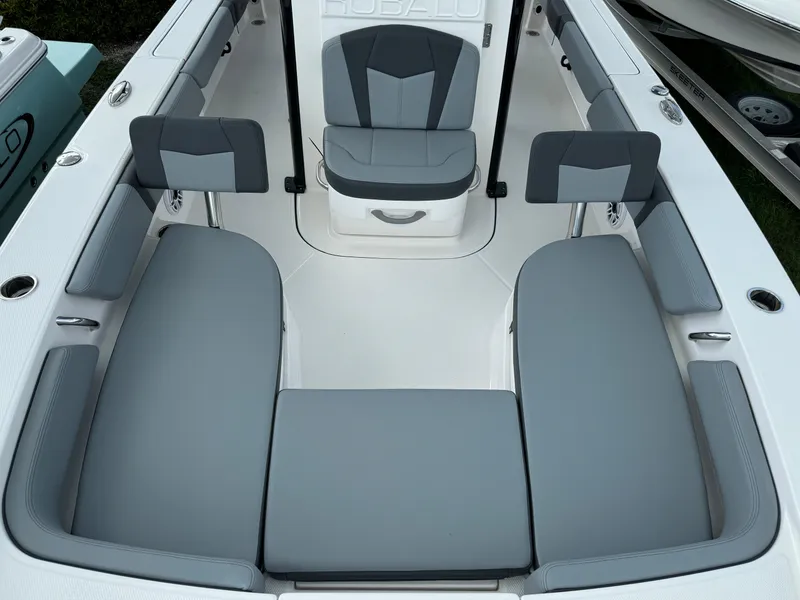 Slide: The Image of 2025 Robalo 246 Cayman boat interior with gray seating and modern design. - 13