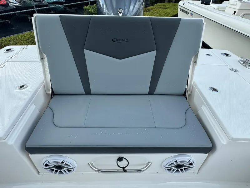 Slide: The Image of 2025 Robalo 246 Cayman boat seat with gray upholstery and built-in speakers. - 19