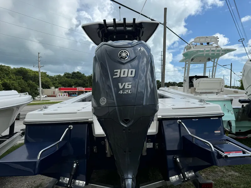Slide: The Image of 2025 Robalo 246 Cayman boat with Yamaha 300 V6 4.2L engine, rear view. - 3