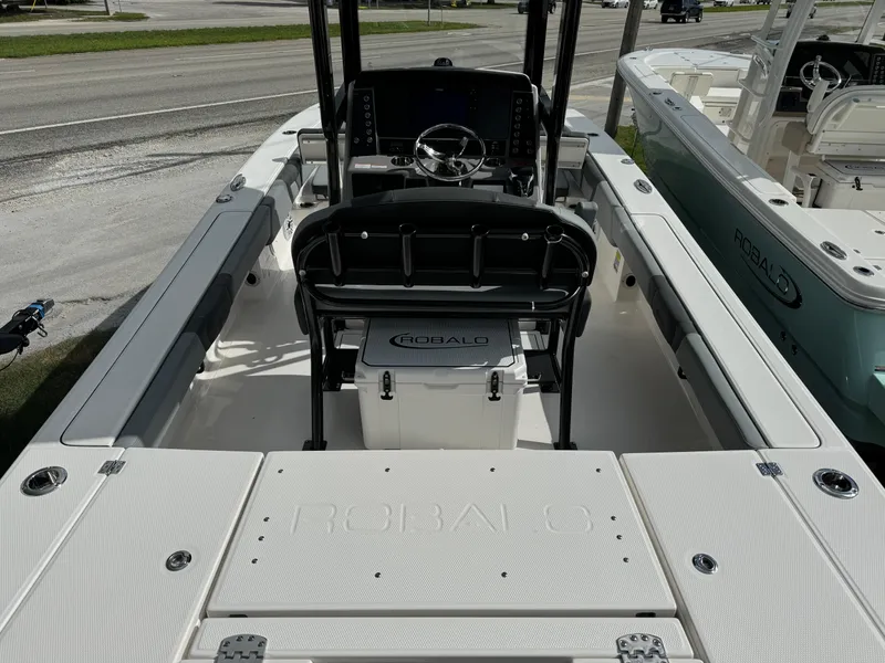 Slide: The Image of 2025 Robalo 246 Cayman boat interior with steering console and seating. - 4