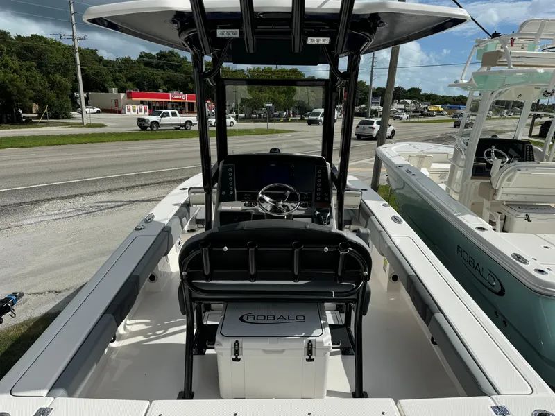 Slide: The Image of 2025 Robalo 246 Cayman boat interior with steering console and seating. - 5