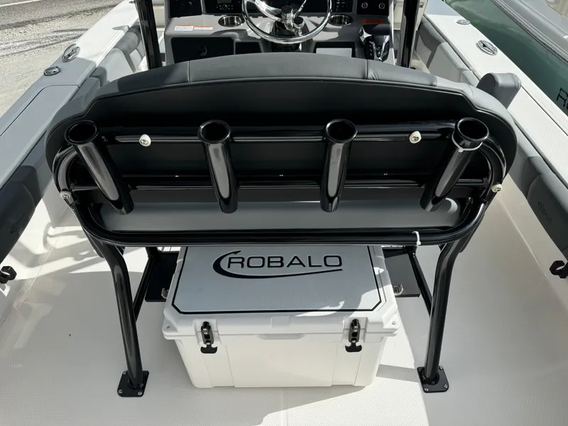 Slide: The Image of 2025 Robalo 246 Cayman boat interior with rod holders and branded cooler. - 6