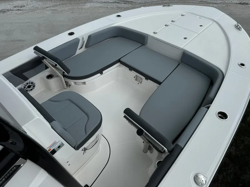 Slide: The Image of 2025 Robalo 246 Cayman boat interior with gray seating and white deck. - 8