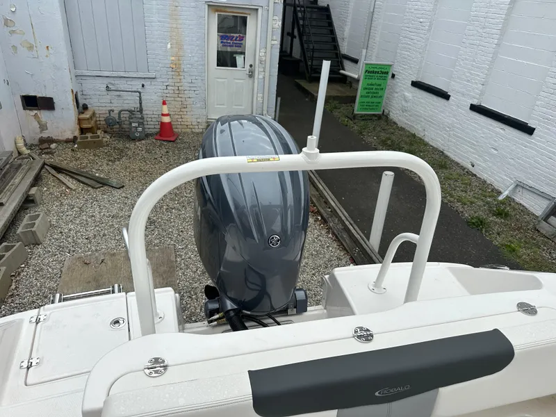 Slide: The Image of 2025 Robalo R202 Explorer boat with outboard motor in a yard setting. - 3