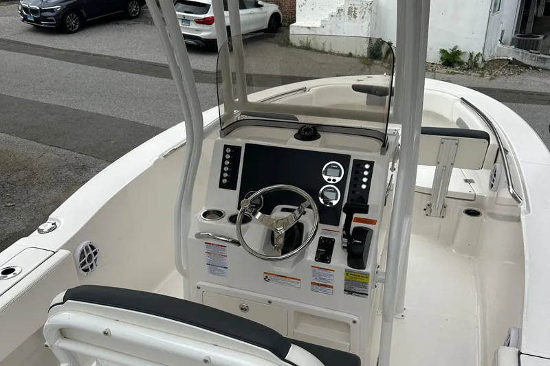Slide: The Image of 2025 Robalo R202 Explorer boat interior with steering console and seating. - 4