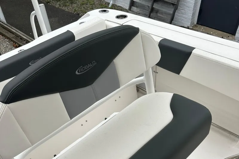 Slide: The Image of 2025 Robalo R202 Explorer boat seating, featuring sleek black and white upholstery. - 6