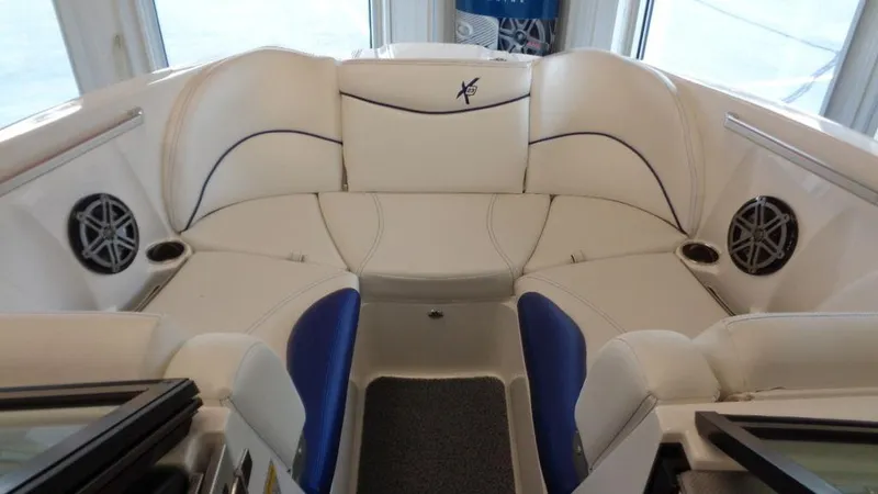 Slide: The Image of 2017 MasterCraft X23 boat interior with white seating and built-in speakers. - 10